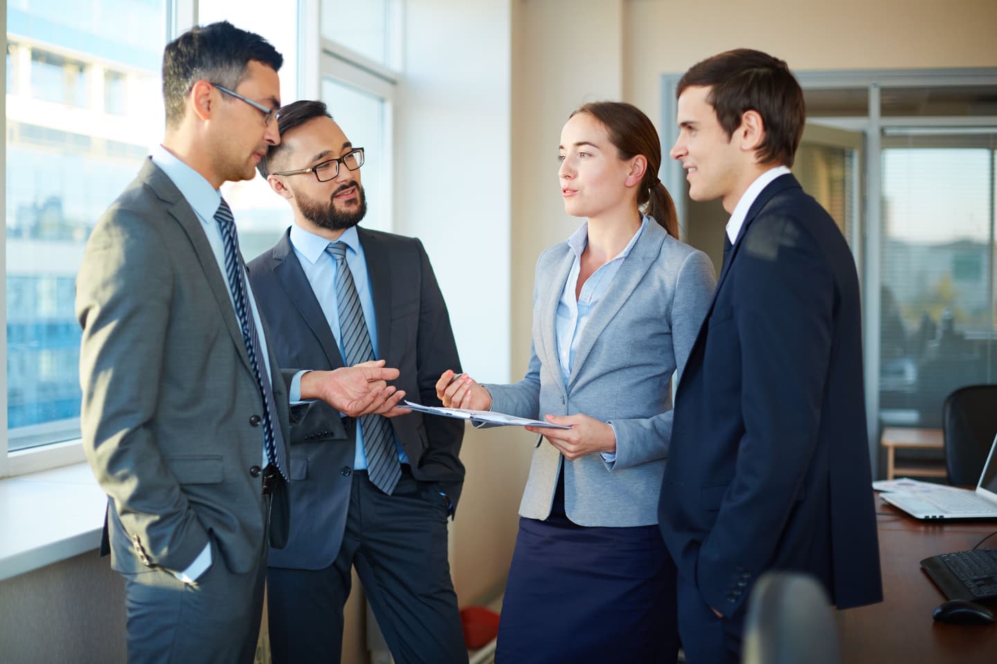 Employees reviewing a document together in an office